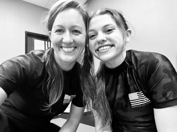 Two smiling Heritage Jiu Jitsu teammates in training gear