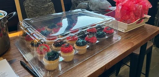 Cupcakes with red and black frosting in a clear tray at a Heritage Jiu Jitsu birthday party